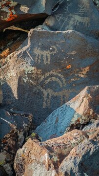 Close-Up View of Archeological Petroglyph Carving on Rough Stone in Natural Outdoor Setting
