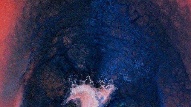 Mixing fragments of alcohol ink on a surface in an art studio