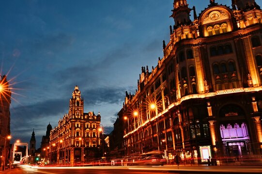 Panoramic evening view, streetscape and skyline of Budapest, Hungary. the newly renovated Klotild twin tower palaces, the Parisian court and the Elizabeth bridge at blue hour. diminishing perspective.