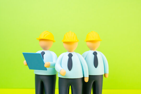 A group of engineers in yellow hard hats and with blueprints. Engineering and design. Construction industry.