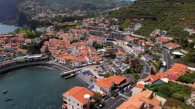 Camara de Lobos Madeira Portugal Aerial Drone Semi Circle Arc Flight over Picturesque Bay with Traditional Fishing Boats and Orange Roof Houses Iconic Island Village Travel Footage 4K UHD