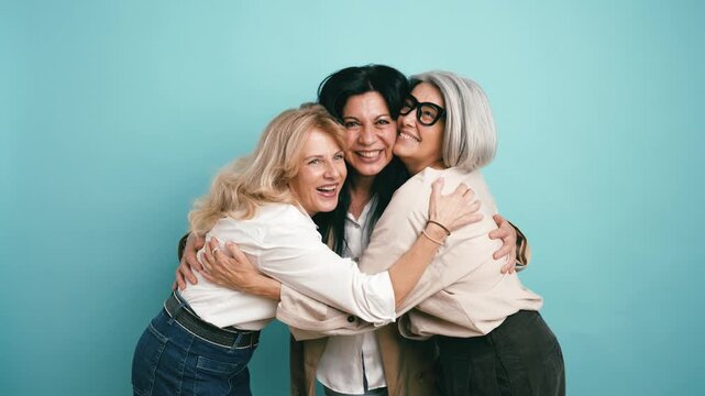Beautiful group of senior female friends laughing and embracing with genuine affection. Joyful moment celebrating their lasting friendship