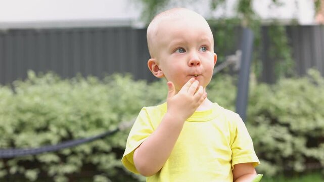 Little boy eats fresh green peas from pod. 4K