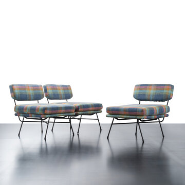 1950s armchairs, featuring a characteristic light structure in black lacquered metal and fabric seat.