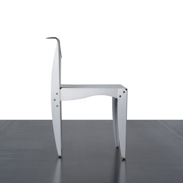 Side view of a white designer chair, made of shaped and curved aluminum.
