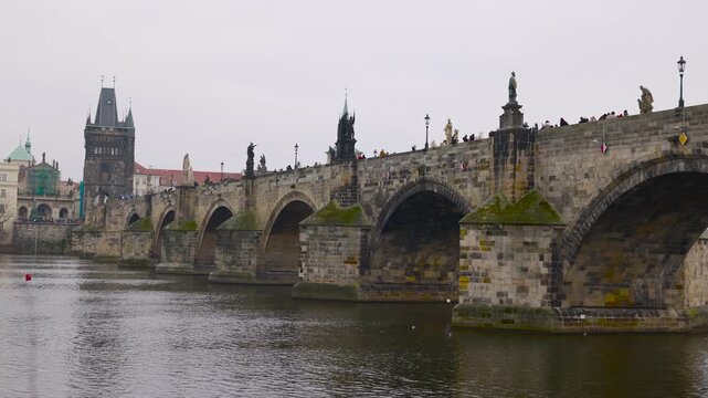Famous charles bridge crossing vltava river in prague. Historic stone charles bridge spanning the vltava river in prague, czech republic. The gothic architecture with its statues and arches