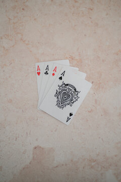 1
Four aces playing cards arranged in a fan on a light stone background. Winning poker hand concept with copy space, ideal for casino, strategy, gambling and card game themes.