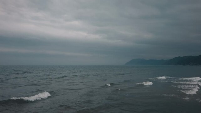 Gray waves lapping onto the shore