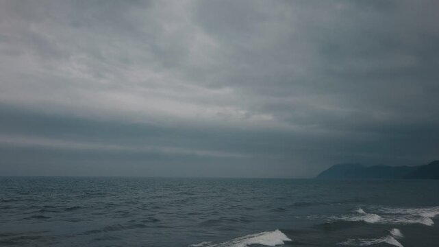Gray waves lapping onto the shore