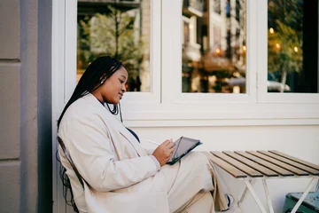 Portrait of freelancer using tablet and stylus pen in outdoor urban setting working on creative project digital nomad lifestyle technology and connectivity concept career growth freelancer, © BullRun
