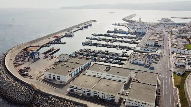 Aerial drone view of fishing boats at Tangier Fishing Port during the morning in Tangier, Morocco