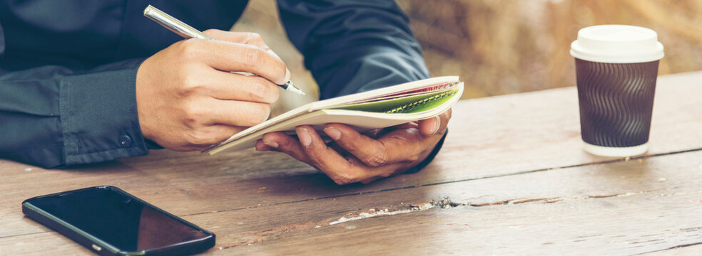 Banner Close up hand man colleagues meeting mergers and acquisitions business. Banner Two Businessman signing contract document dealing teamwork. Partners Signed document at office with copy space