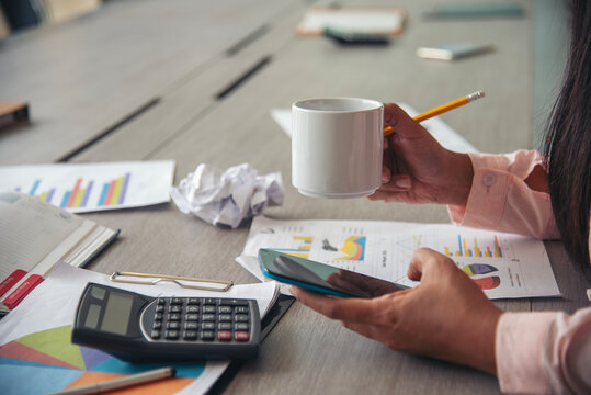 Audit Businesswoman at office desk. Close up businesswoman hands audit accountant using calculator, business graph chart working at home office. Woman Hands working home do accounting small