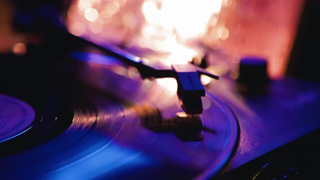 Vinyl record spinning on a classic turntable. Close up of sound stylus playing music. Retro audio equipment with warm lighting for vintage musical listening mood.