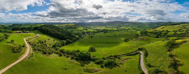An aerial perspective of the lush green pastures and winding lanes looking towards Llansilin near Oswestry on the border of Shropshire and Wales. © steheap