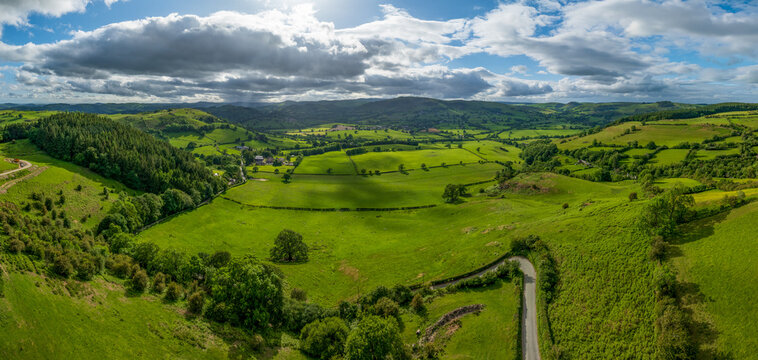 An aerial perspective of the lush green pastures and winding lanes looking towards Llansilin near Oswestry on the border of Shropshire and Wales.