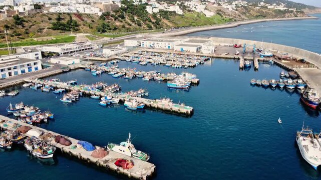 Aerial drone view of fishing boats at Tangier Fishing Port during the morning in Tangier, Morocco