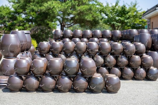 Traditional Korean onggi jars stacked in two rows outdoors