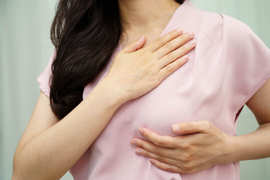 Asian woman self touching check lump or Breast cancer, Breast Self Exam.