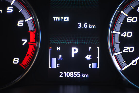 Digital dashboard speedometer tachometer odometer trip meter vehicle instrument panel car display fuel gauge engine temperature gauge mileage 3.6 km 210855 km parking gear illuminated panel black