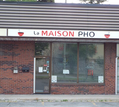 Gatineau,Quebec, Canada &ndash; May June 2, 2026:  A storefront featuring the" La Maison Pho" restaurant sign with an Ouvert notice sits on Rue Principale in Gatineau on 4 Rue Belmont.