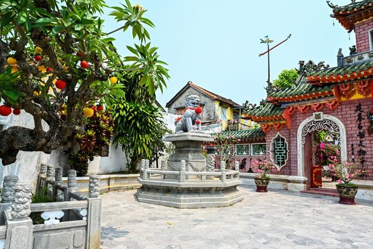 Traditional stone lion statue at inner courtyard next to ornate gate of the Fujian Assembly Hall temple