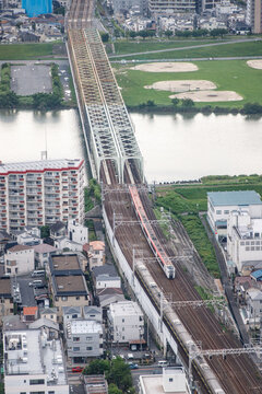 Train Crossing a Bridge Over a River Near a City