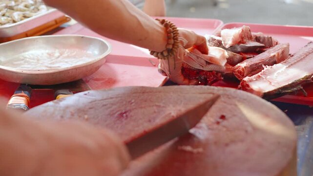 Fish Vendor Displaying Freshly Cut Fish at a Local Market