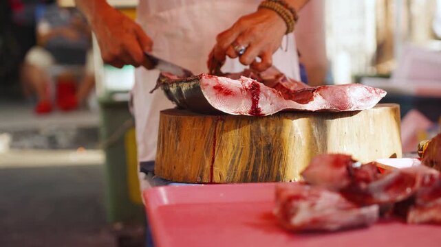 Fish Vendor Gutting Fresh Fish at a Local Market