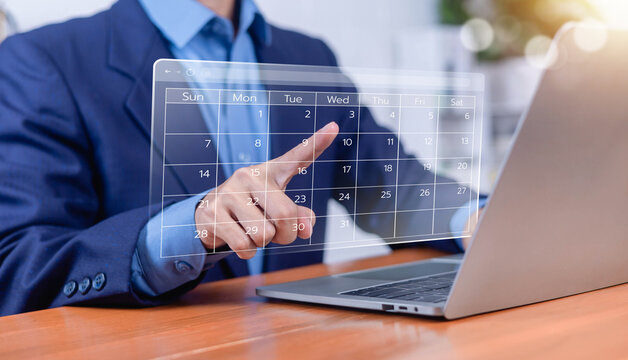 Business professional managing a digital calendar on a virtual interface, representing online scheduling, appointment booking, project planning, time management, business organization.
