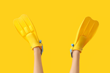 Young woman with flippers on yellow background © Pixel-Shot