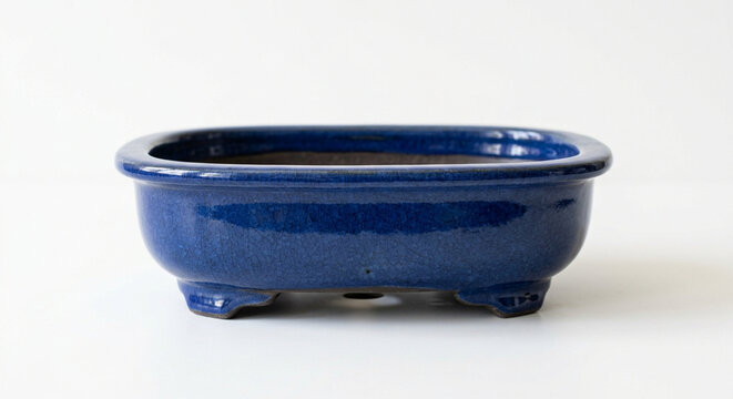 Empty glossy deep blue ceramic rectangular planter pot with feet, ideal for bonsai trees or small plants on a clean white background