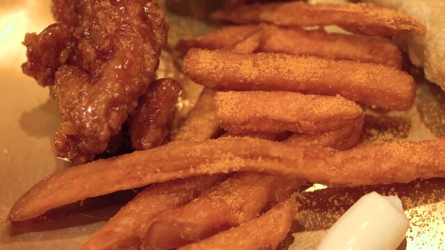 Close Up of Korean Fried Chicken and Seasoned French Fries