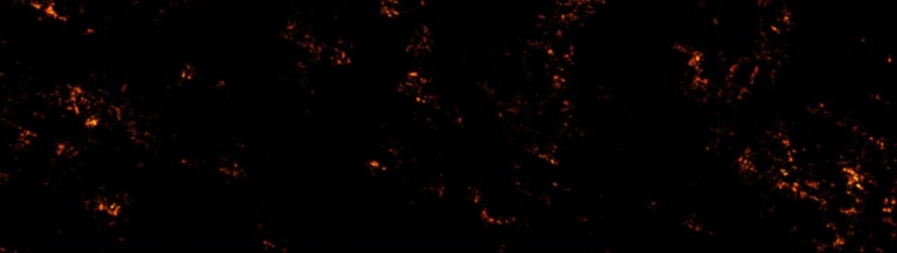 Fiery streaks of light move across black background slow motion abstract glowing energy flares dynamic.