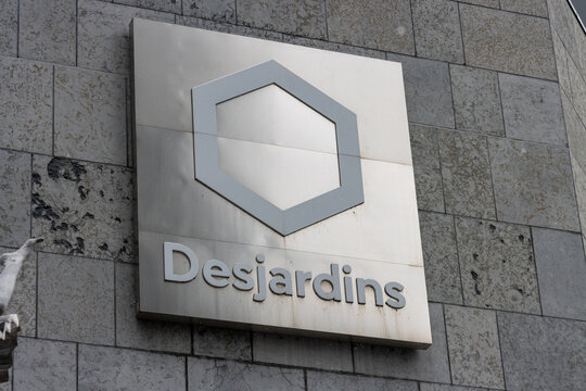 MONTREAL, CANADA, 23 December 2025 : Building exterior, Desjardins logo, stone wall, corporate signage, architectural design