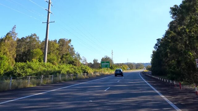 Driving on Pacific Highway Through Lush Forest in New South Wales