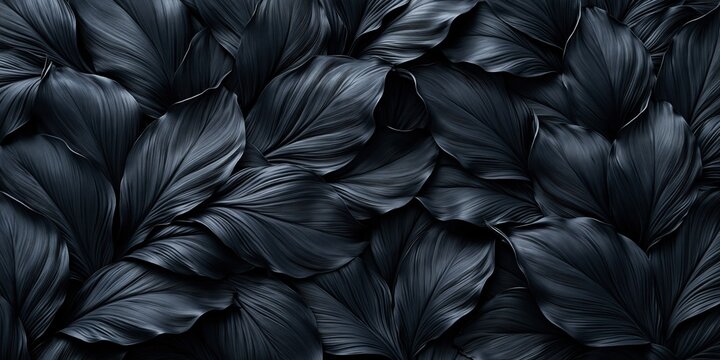 Black leaves forming a moody organic texture pattern in a dark nature background