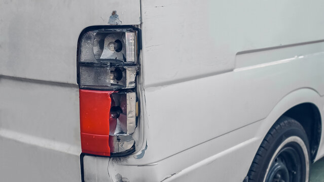 The rear tail light is damaged. The lens is cracked, the body panel is dented, and the rear bumper is scratched.