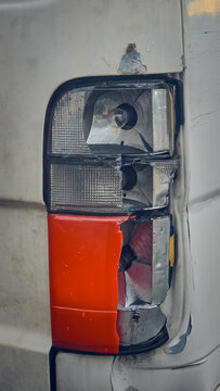The rear tail light is damaged. The lens is cracked, the body panel is dented, and the rear bumper is scratched.