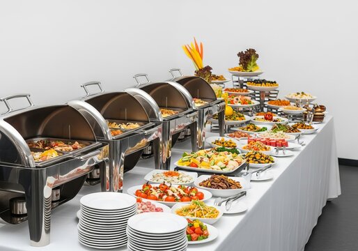 Pristine restaurant buffet arrangement featuring polished steel chafing dishes, ceramic plates, and fresh culinary displays on a long table, table, breakfast, glass