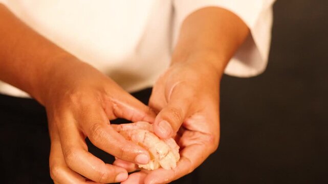 Professional Chef Handcrafting Fresh Amaebi Shrimp Nigiri Sushi