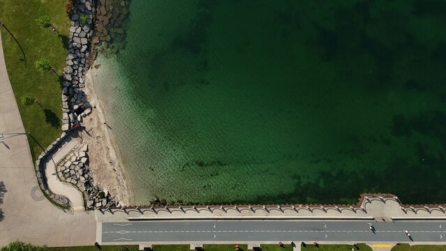 Aerial View of Lakeside Waterfront Trail and Green Water Shoreline