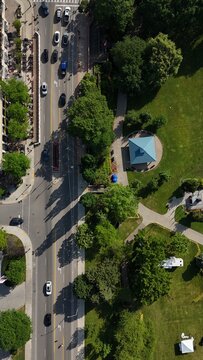 Aerial View of Urban Street and Green City Park with Walking Paths