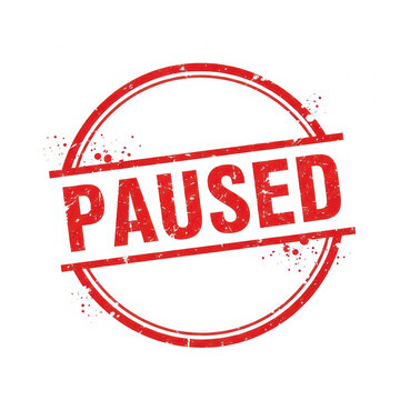 Red round rubber stamp with the word PAUSED in a grunge texture style