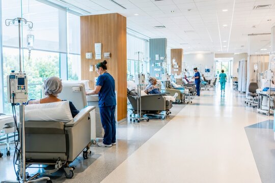 Dialysis treatment center with nurse and patient in bright hospital ward