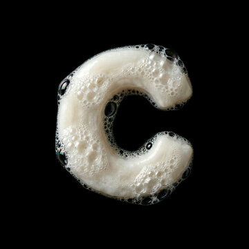 Solid soap with bubbles and foam letter C - large creative font isolated on black background. Perfect alphabet for creative illustrations related to beauty, hygiene, purity...