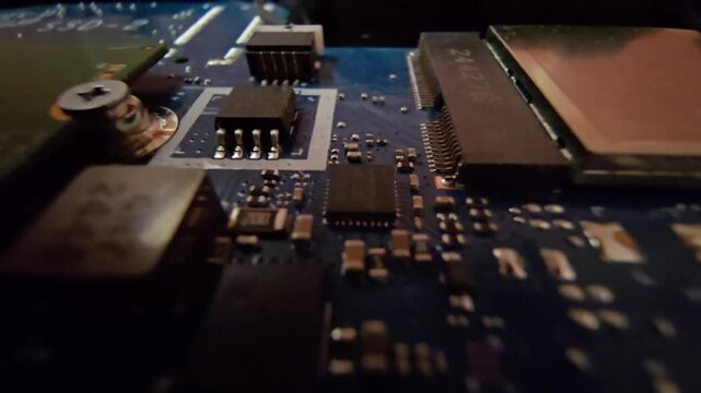 Close-up of a laptop motherboard showing surface-mount electronic components and text printed on the circuit board that reads "Tamper Lock ON" and "Tamper Lock OFF".