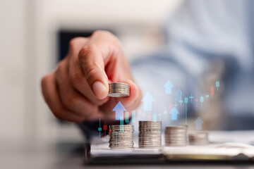 Financial growth and stock market investment concept. Businessman stacking coins with upward arrows and candlestick chart.