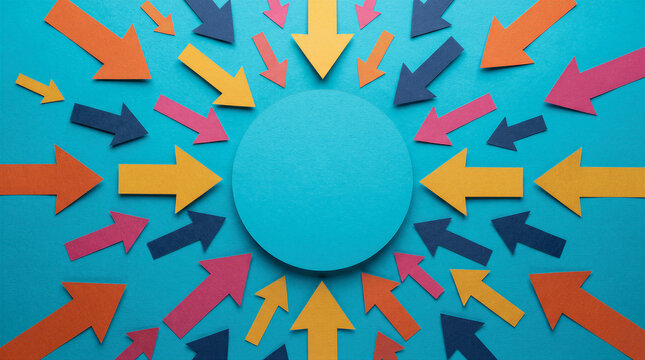 Top view of colorful paper arrows pointing to a central blue circle on a blue background, representing focus, direction, and teamwork