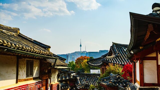 This 4K time-lapse video shows Bukchon Village as a fantastic place to visit during autumn when the leaves change color, on a clear day in Seoul, South Korea.